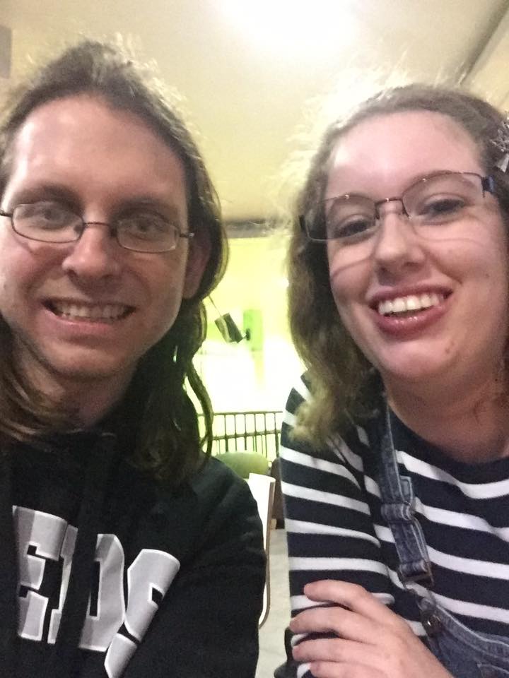 A selfie of myself & my husband as students. I'm wearing a navy blue & white striped jumper & blue dungarees, & Jarred is wearing a black University of Leeds hoodie.