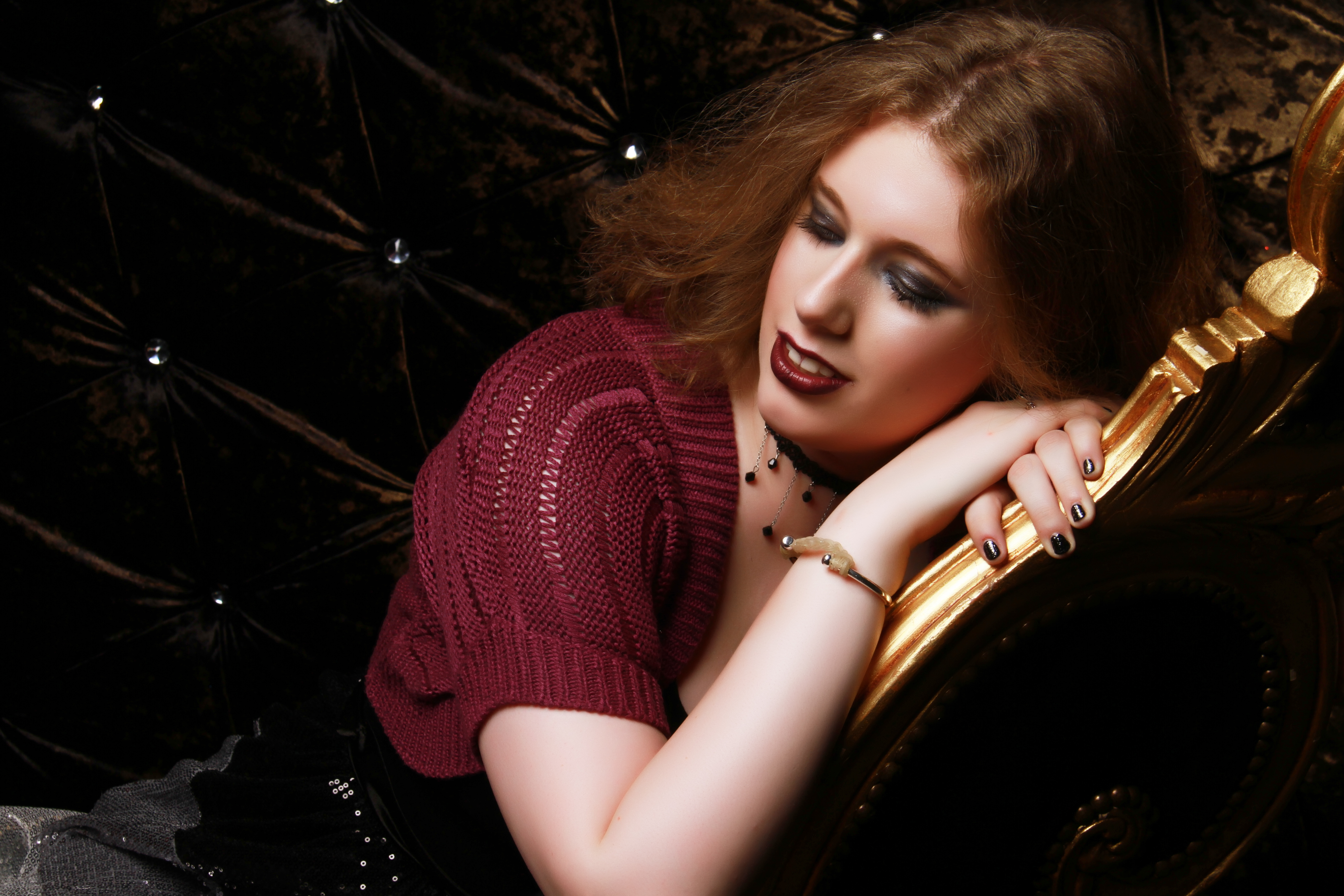 Taken at the same photo shoot. I'm resting my head on my crossed hands, which are placed on the back of the chair. The photo was taken at an angle to make the pose look more natural. I'm wearing a black dress with a skirt of silver sequins, & a purple cardigan.