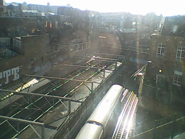 The view from the hotel window overlooking the train tracks as a tube train speeds underneath us.