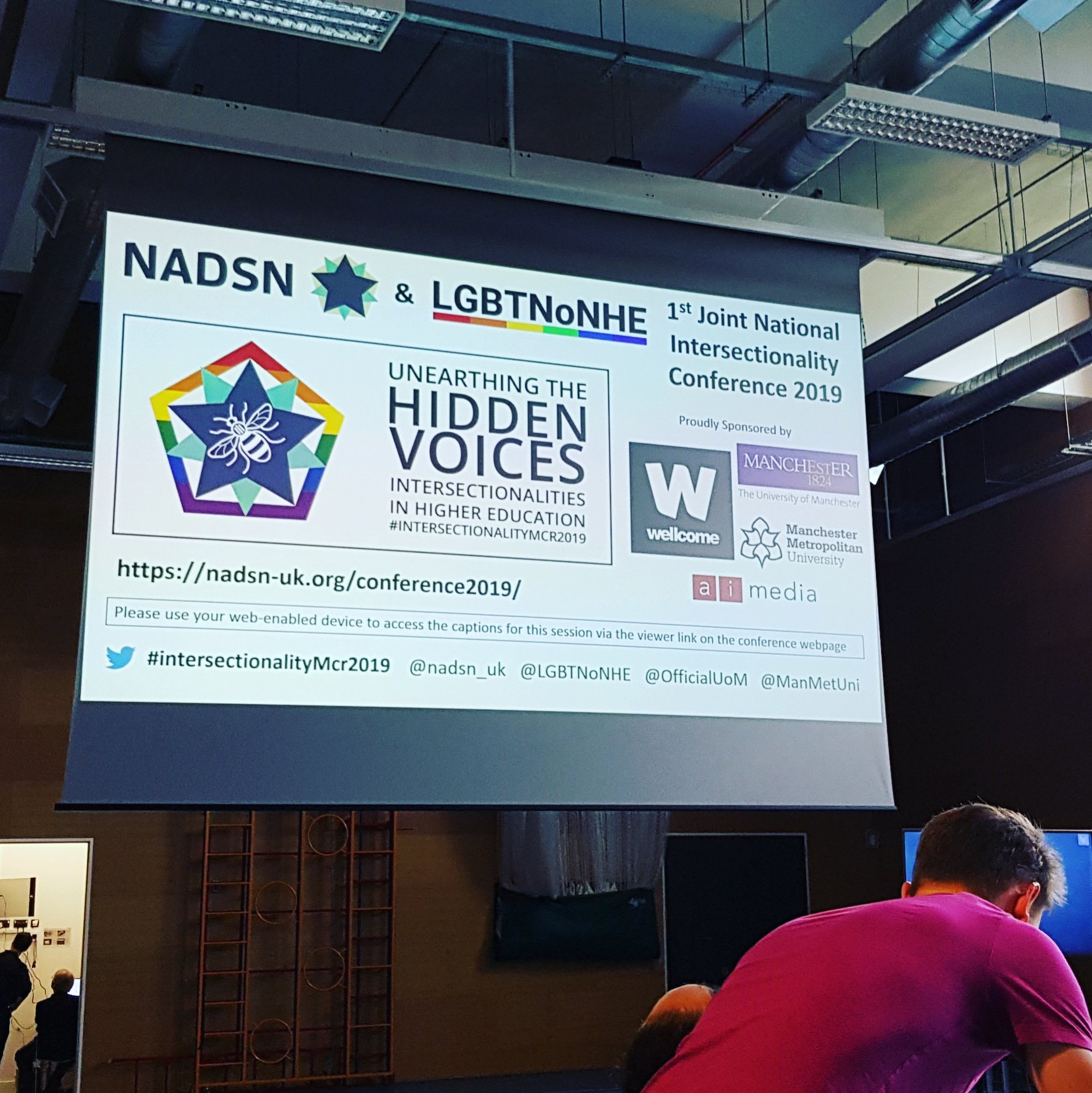 The opening screen of the conference presentation, projected onto a pull-down screen in the sports hall.
