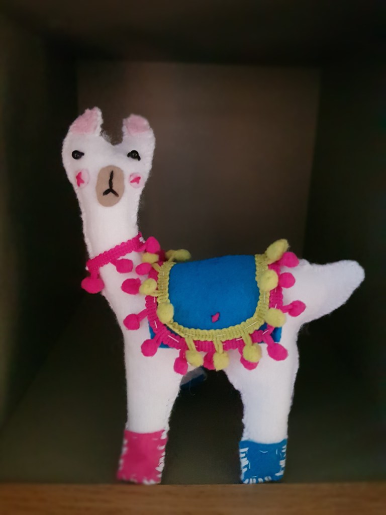 A white felt llama.
