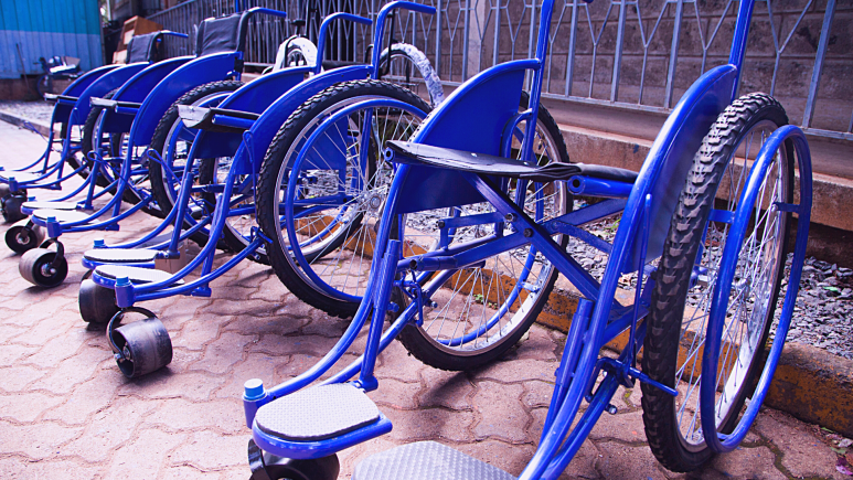 Empty blue wheelchairs in a row.
