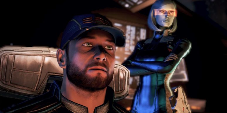 Joker sits in his chair, with the droid EDI stood behind him.