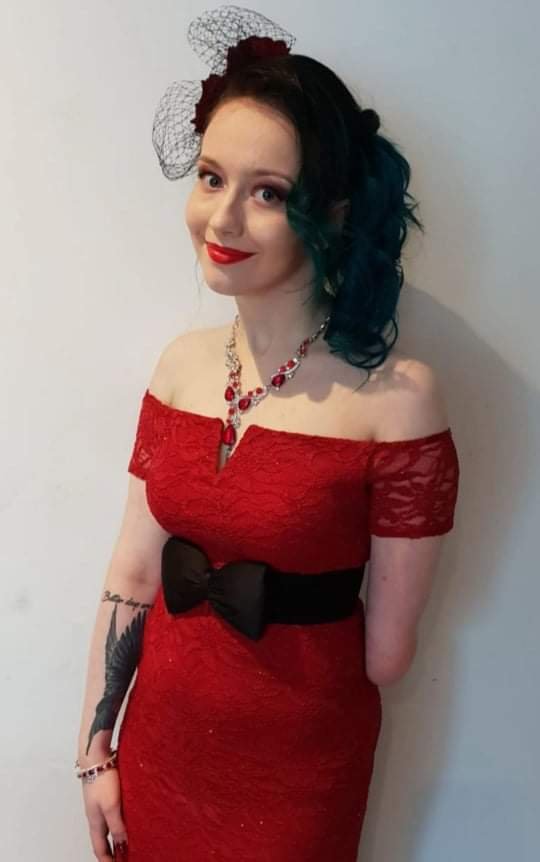 Wiki as my bridesmaid, wearing a red off-shoulder lace dress with a black bow.