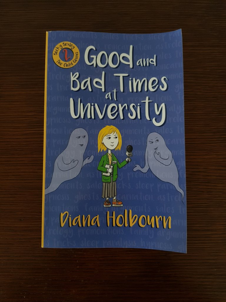 Book 2: Good and bad times at university. This book shows the same girl speaking to two ghosts with a microphone, on a dark blue cover.