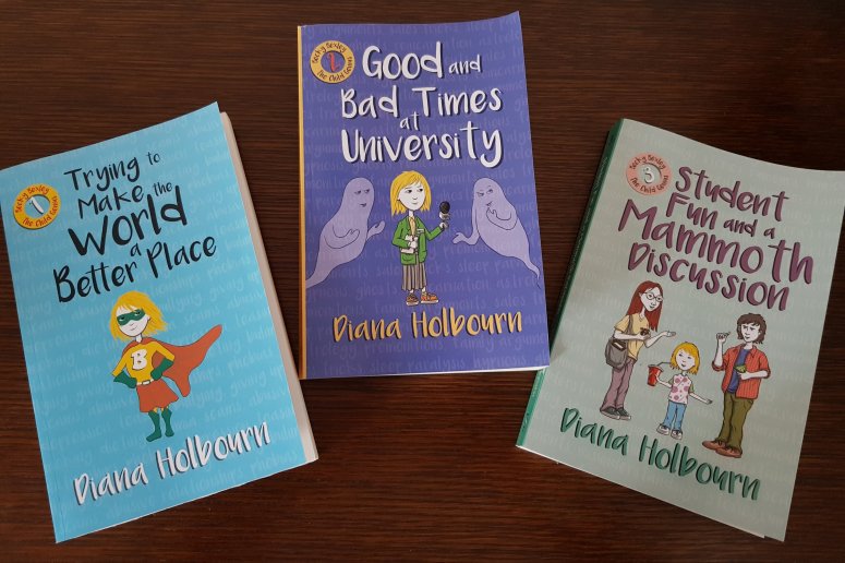 The trilogy of Becky Bexley books resting on a dark brown wood surface.